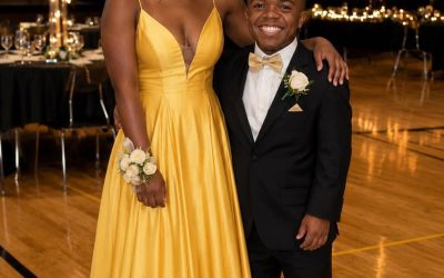 Everyone at school laughed at my boyfriend because of his height — but at prom, our teacher called us onto the stage and said words that left the entire room speechless.  Two years ago, a boy named Elliot transferred into our class. He was very short, and our classmates constantly made fun of him.  But not me.  We became friends in the first few days after he transferred to our school.  We started spending a lot of time together, and eventually, I fell in love with him.  We started dating and basically became the “”popular”” couple at school because people started making fun of me too.  Elliot has achondroplasia. He’s short, but I didn’t care.  He’s kind, funny, and an amazing guy. He treated me wonderfully, and even my parents adored him.  Then prom night finally came.  I wore the most beautiful dress my mom and I had picked out together, and Elliot knocked on my door and picked me up for prom like a true gentleman.  The second we walked into the school, the teasing started again.  Someone shouted:  “”Oh my God, did you bring your little brother? Is he, like, 5 years old?””  Another classmate yelled:  “”Looks like one and a half people showed up to prom!””  Still, we ignored them.  And while all the other guys were asking girls to dance, Elliot led me to the center of the dance floor like I was a queen and danced with me.  Then one of the girls shouted again:  “”Maybe you should just pick him up and dance with him like he’s a child!””  Tears were already filling my eyes, and I quietly suggested to Elliot that we should leave.  But suddenly, someone tapped me on the shoulder.  It was Mrs. Parker, our math teacher.  She asked Elliot and me to come up onstage.  Onstage, Mrs. Parker turned off the music. We stood beside her.  Everyone in the room immediately started complaining and groaning.  Then she grabbed the microphone and said:  “”Everyone, quiet down RIGHT NOW! I have something IMPORTANT to say about Elliot, and I need all of you to listen.””  She kept speaking, and I felt the air leave my lungs as the entire room fell silent and HELD ITS BREATH (I know you’re all very curious about the next part, so if you want to read more, please leave a “”YES”” comment below!) See less Comments Flores Carlos